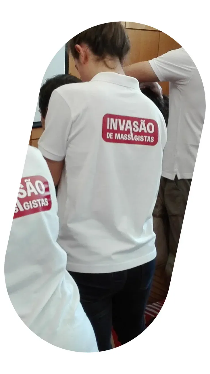 Masseuses in white shirts working in an open-plan office.