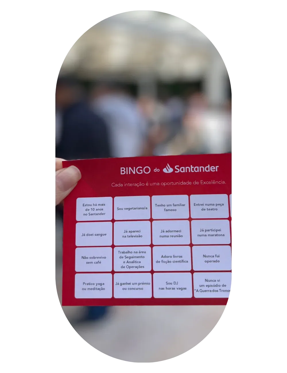 A personalised bingo card resting on a laid table during a company meal.